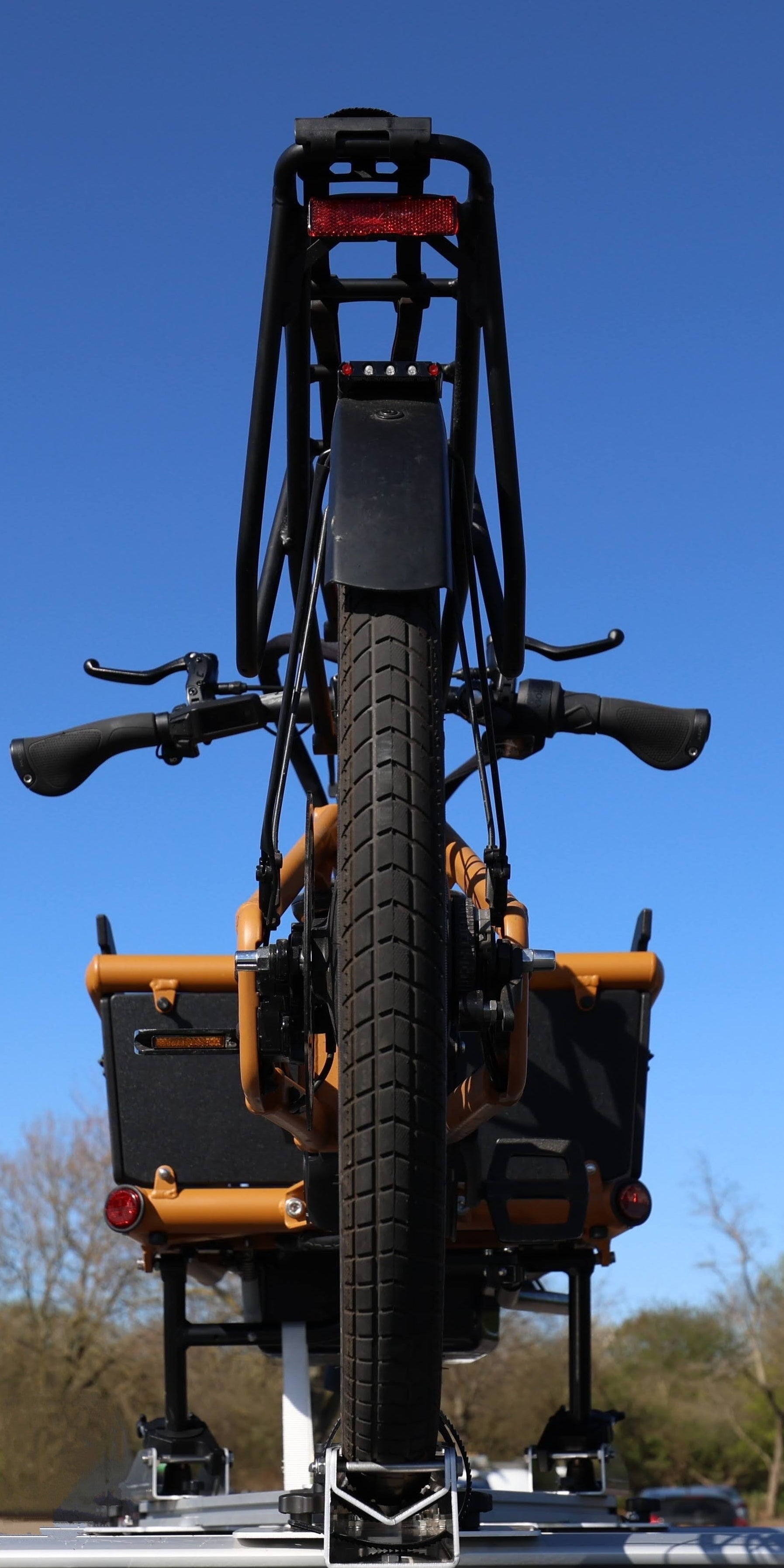 Cargo Bikemounted on a trailer against a clear blue sky